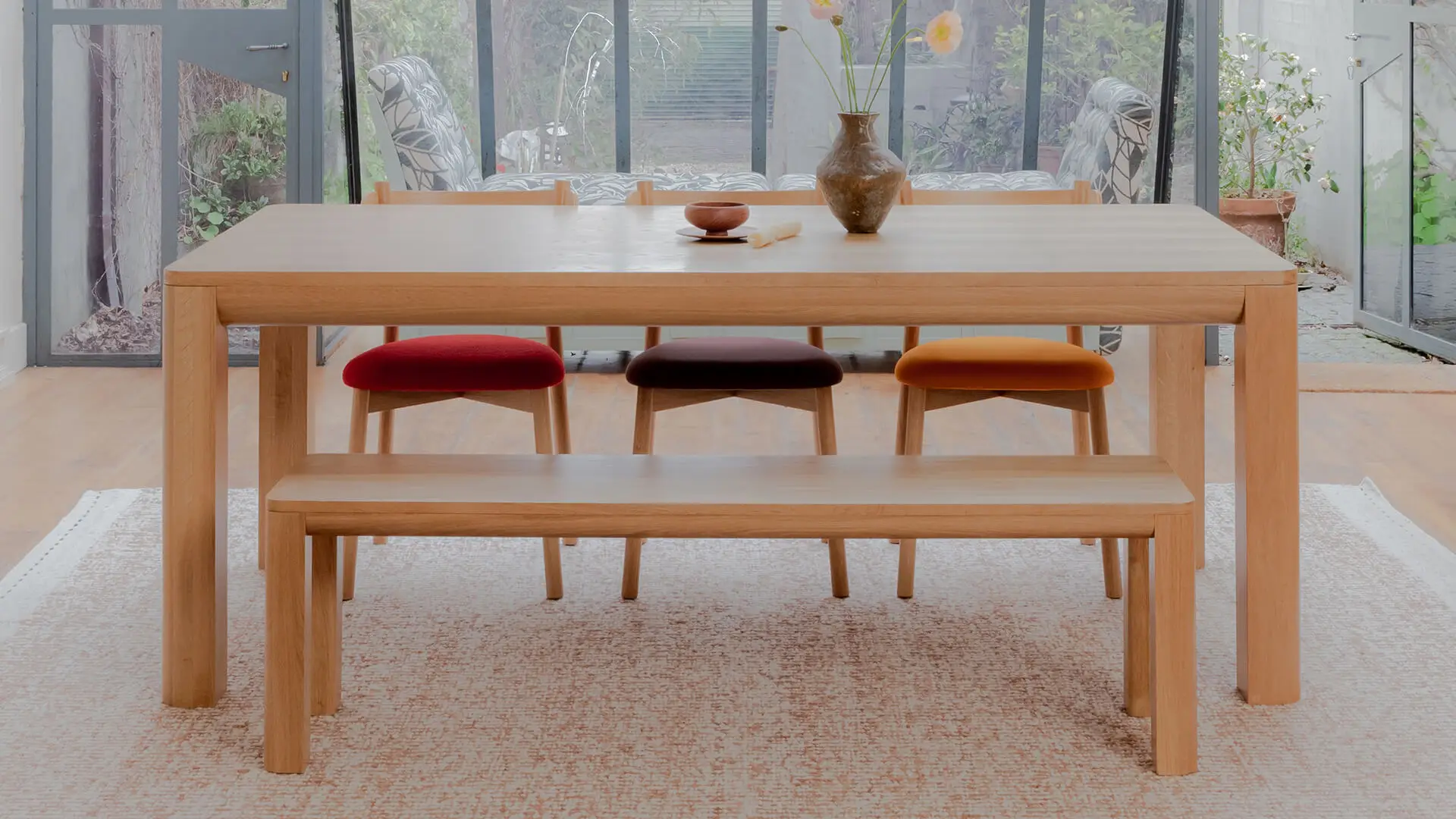 Alor dining set in American oak with Charlie dining chairs in three different colored upholstered sear pads