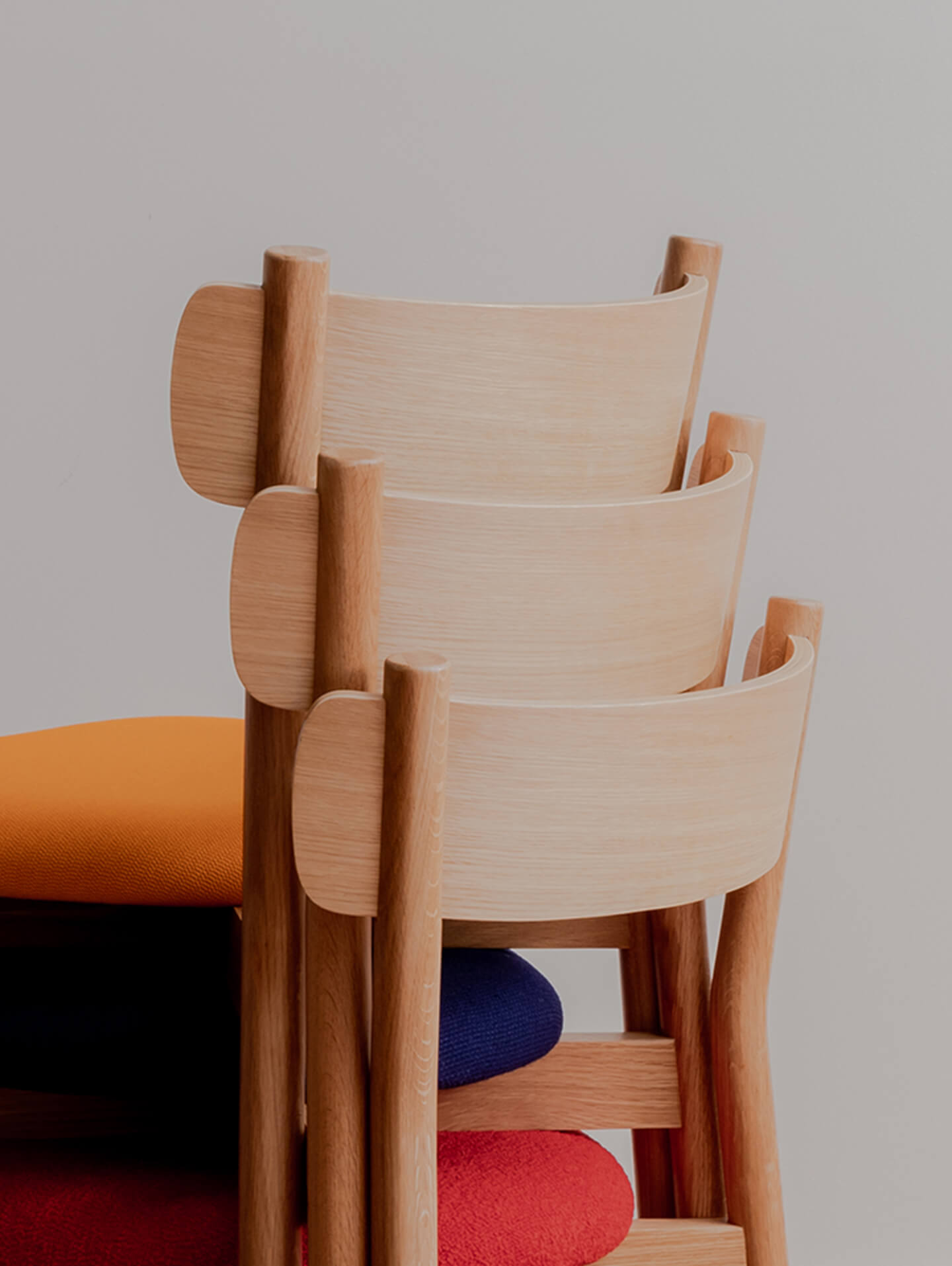 Detail of charlie dining chair back rest stacked three high. Designed in Australia and made from FSC certified timbers