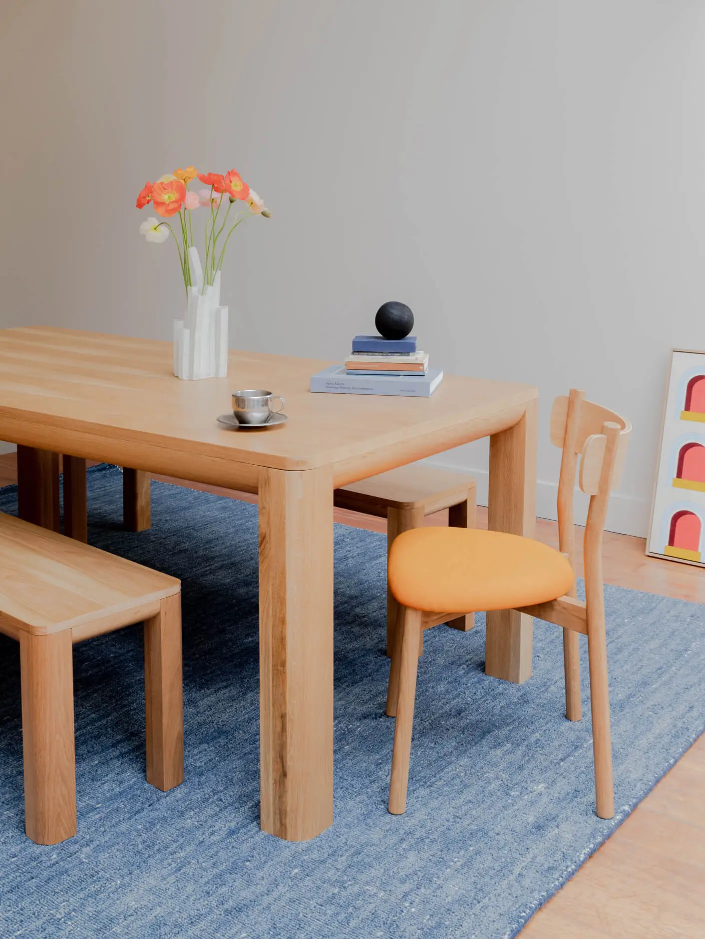 Alor dining set with american oak Frankie dining table, charlie dining chair and a Bowie bench seat, with flowers in an abstract vase on table