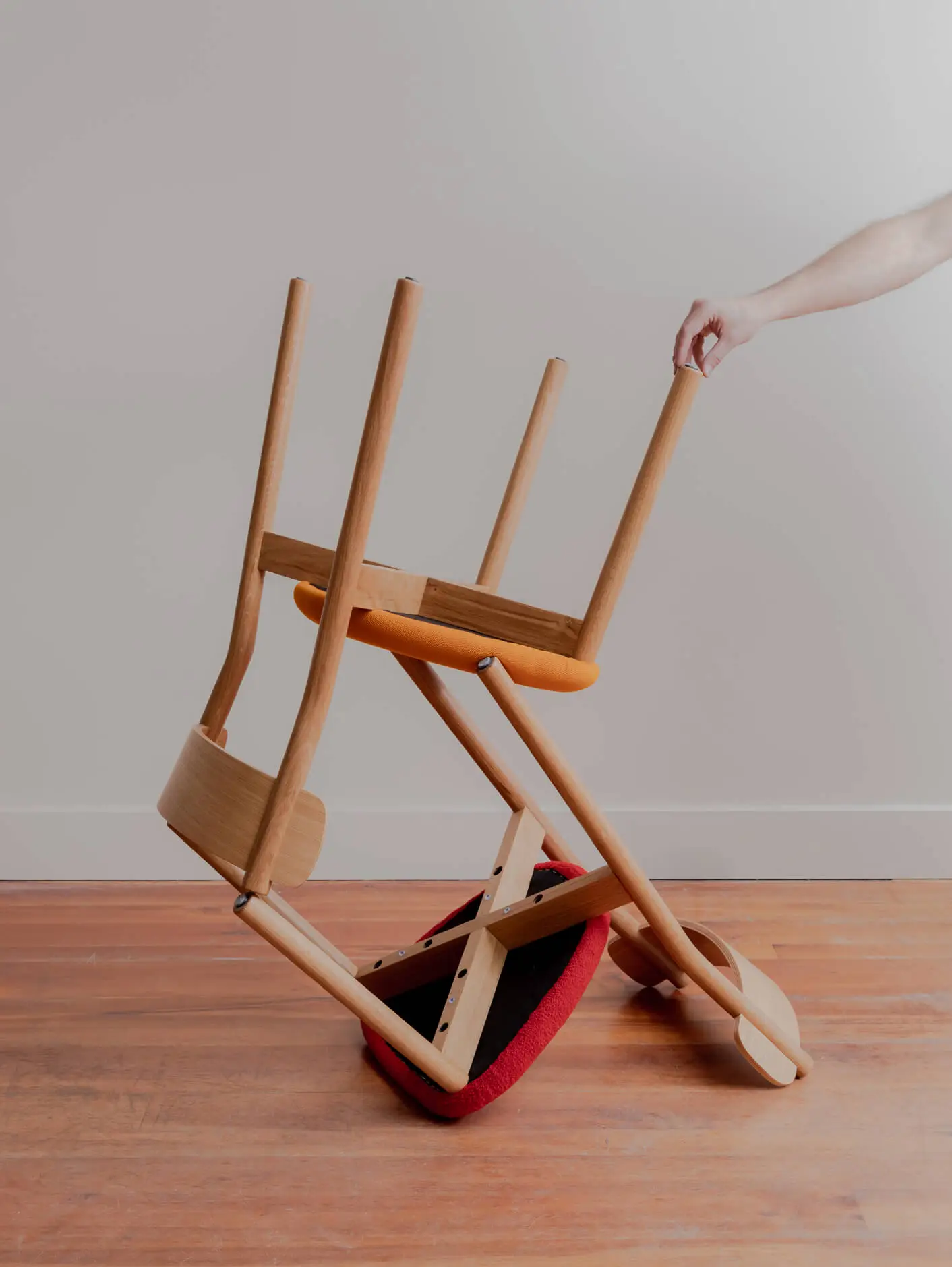 American Oak Charlie Dining chairs stacked upside down on top of each other