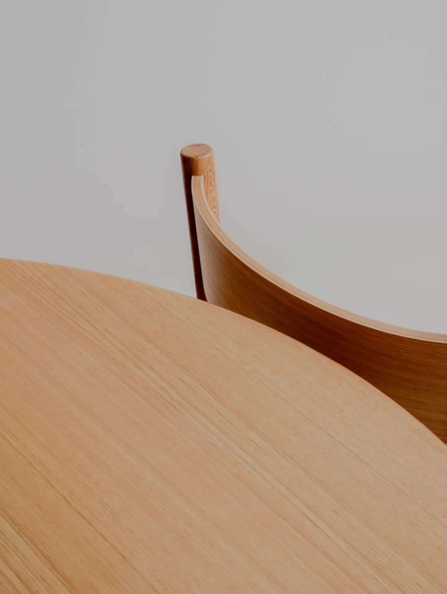 Close up image of wooden table and the Charlie dining chair in American Oak